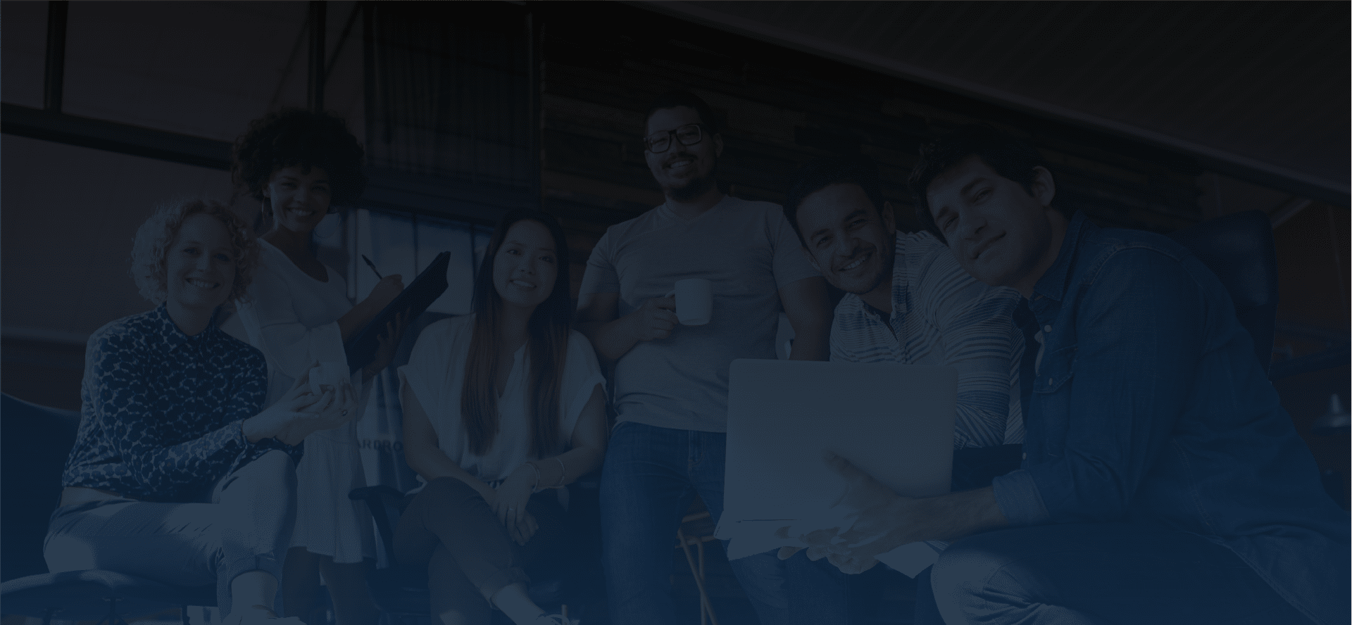 group of smiling young professionals at work