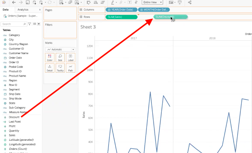 arrow highlighting path to drag discount data field to rows bar in tableau
