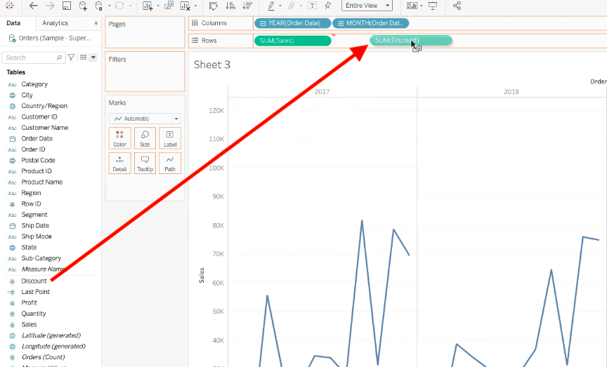 arrow highlighting path to drag discount data field to rows bar in tableau