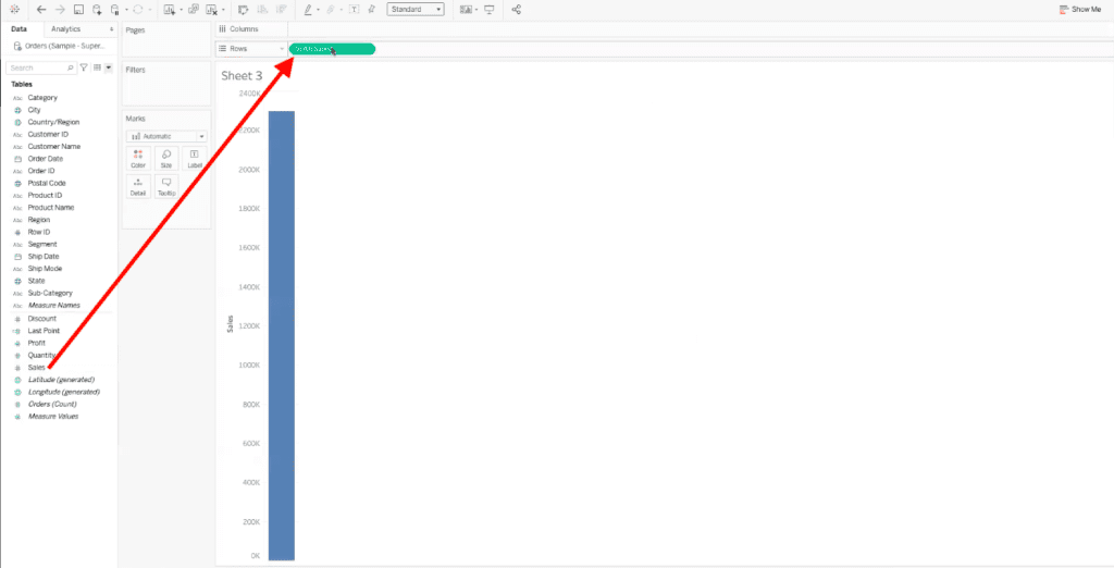 arrow highlighting path to drag sum of sales data field to rows bar in tableau dashboard