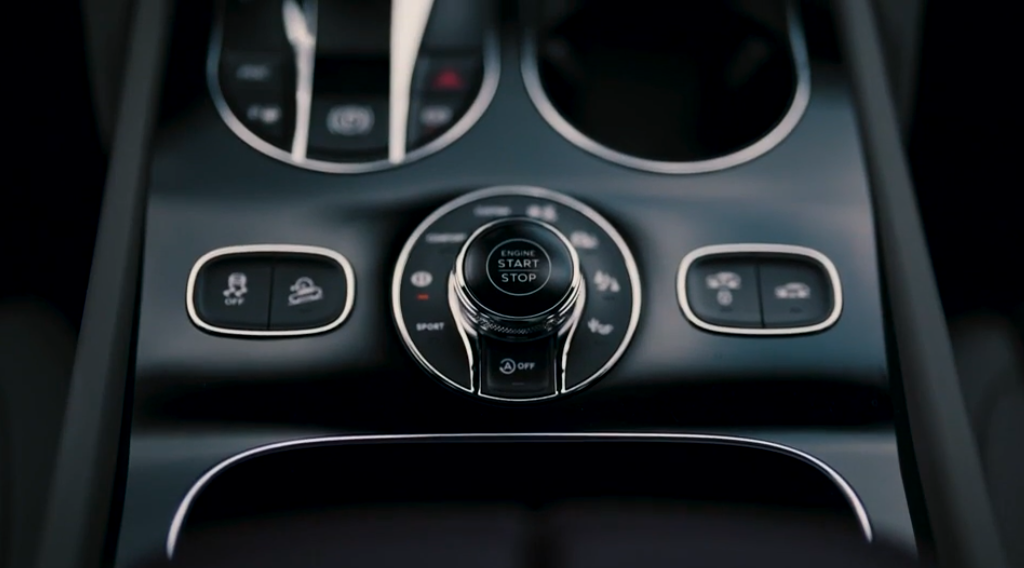car dashboard focused on the start/stop engine button